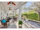 Beautiful screened patio with comfortable seating, ceiling fans, and a serene view of the garden at 65 Calumet Ave, Ponce Inlet, FL 32127