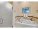 Bathroom features a jacuzzi tub and glass door shower at 65 Calumet Ave, Ponce Inlet, FL 32127