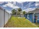The spacious backyard includes a white privacy fence, green lawn, and mature trees providing ample shade at 711 Hiview Cir, Port Orange, FL 32127