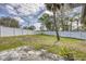 A spacious backyard featuring a well-maintained lawn and a white privacy fence at 711 Hiview Cir, Port Orange, FL 32127