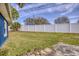 A spacious backyard featuring a well-maintained lawn and a white privacy fence at 711 Hiview Cir, Port Orange, FL 32127