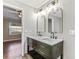 Bathroom features a dual sink vanity with marble countertop, modern fixtures, and ample lighting at 711 Hiview Cir, Port Orange, FL 32127