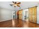 Bedroom features barn doors leading to closet and bathroom, along with a modern ceiling fan at 711 Hiview Cir, Port Orange, FL 32127