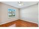 Bright bedroom featuring hardwood floors, a ceiling fan, and a window with natural light at 711 Hiview Cir, Port Orange, FL 32127