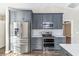 Modern kitchen featuring stainless steel appliances, sleek gray cabinets, and stylish finishes at 711 Hiview Cir, Port Orange, FL 32127