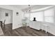 Eat-in kitchen area with a large sunny window, white furnishings, and dark, hardwood-style flooring at 898 Glasgow Ave, Deltona, FL 32738