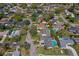 Neighborhood aerial view of the property showcasing lush green trees, manicured lawns, and community pools at 901 Ponca Trl, Maitland, FL 32751