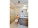 Bathroom featuring a granite vanity, a shower with sliding door, and unique tile flooring at 901 Ponca Trl, Maitland, FL 32751