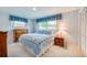 Cozy bedroom with blue accents, including curtains, bedding and classic wood furniture at 901 Ponca Trl, Maitland, FL 32751