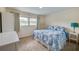 Comfortable bedroom with large window, neutral walls, and blue and white patterned bedding at 901 Ponca Trl, Maitland, FL 32751