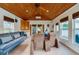 Spacious bonus room with a wood ceiling, large windows, comfortable seating, and access to the outdoor area at 901 Ponca Trl, Maitland, FL 32751