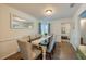 Dining room with seating for six, wood floors, wainscoting and updated lighting at 901 Ponca Trl, Maitland, FL 32751
