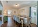 Elegant dining room with seating for six, wood-look tile flooring, and a large decorative mirror at 901 Ponca Trl, Maitland, FL 32751