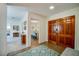Inviting foyer featuring beautiful wood flooring, a colorful rug, and a glimpse into the dining and living areas at 901 Ponca Trl, Maitland, FL 32751