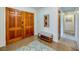 Inviting foyer with double doors, tile flooring, and a comfortable bench with shoe rack at 901 Ponca Trl, Maitland, FL 32751