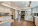 Bright kitchen featuring white cabinets, stainless steel appliances, and wood-look tile flooring at 901 Ponca Trl, Maitland, FL 32751