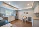 Well-lit kitchen featuring stainless steel appliances, white cabinetry, and a cozy breakfast nook at 901 Ponca Trl, Maitland, FL 32751