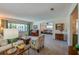 Bright living room featuring plush seating, a piano, and views into a separate seating area at 901 Ponca Trl, Maitland, FL 32751