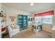 Bright sewing room with built-in shelves, a crafting table, and comfortable seating at 901 Ponca Trl, Maitland, FL 32751