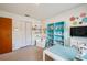 Well-lit crafting room with custom blue shelving and charming decor at 901 Ponca Trl, Maitland, FL 32751