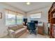 Functional office space with a sofa, desk, and built-in bookshelves, ideal for remote work at 901 Ponca Trl, Maitland, FL 32751