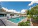 Refreshing pool surrounded by a brick patio, potted plants, and lush landscaping, perfect for outdoor enjoyment at 901 Ponca Trl, Maitland, FL 32751