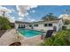 The in-ground pool features a brick deck, manicured landscaping, and ample room for relaxing and entertaining at 901 Ponca Trl, Maitland, FL 32751