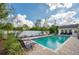 Inviting in-ground pool with brick paver patio, lounge chairs, and white fence at 901 Ponca Trl, Maitland, FL 32751