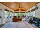Relaxing sun room featuring a wood ceiling, floor-to-ceiling windows, and cozy seating at 901 Ponca Trl, Maitland, FL 32751