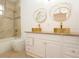 Bathroom featuring double vessel sinks, granite countertops, and modern gold fixtures at 926 Sycamore St, Daytona Beach, FL 32114