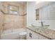 Bathroom with glass vessel sink, granite counters, and tiled shower and tub combo at 926 Sycamore St, Daytona Beach, FL 32114