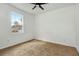 Bedroom showcasing the fan and a bright window, with neutral carpet at 926 Sycamore St, Daytona Beach, FL 32114
