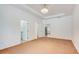Bright bedroom with neutral carpet, tray ceiling, and multiple entryways at 926 Sycamore St, Daytona Beach, FL 32114
