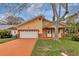 Inviting single Gathering home featuring a two-car garage and charming front porch with decorative columns at 926 Sycamore St, Daytona Beach, FL 32114
