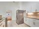 Kitchen featuring stainless steel refrigerator, granite countertops, and tiled floors at 926 Sycamore St, Daytona Beach, FL 32114