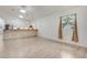Open living space with tile floors, a kitchen island, and bright natural light from a large window at 926 Sycamore St, Daytona Beach, FL 32114