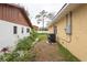 Side yard featuring well-maintained landscaping and a modern air conditioning unit at 926 Sycamore St, Daytona Beach, FL 32114