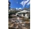 The rear of the home features a sizable yard with lush greenery, a car park, and perimeter fencing at 961 Oakwood Rd, Orange City, FL 32763