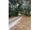 Long, private driveway winding through lush trees, leading to the home, enhancing its curb appeal at 961 Oakwood Rd, Orange City, FL 32763
