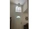 This entryway showcases a high ceiling, transom window, and elegant light fixture at 961 Oakwood Rd, Orange City, FL 32763