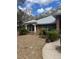 A cozy single-Gathering home with tidy landscaping, complemented by mature trees and a welcoming walkway at 961 Oakwood Rd, Orange City, FL 32763