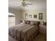 This main bedroom has neutral decor, a ceiling fan, and a window bringing in natural light at 961 Oakwood Rd, Orange City, FL 32763