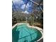 Beautiful screened-in pool with crystal clear water and ample space for lounging at 961 Oakwood Rd, Orange City, FL 32763