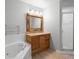 Bathroom featuring a large, ornate mirror, tub, and glass enclosed shower at 1576 Naples Cir, Deltona, FL 32738