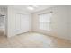 This bedroom features tile flooring, a large window, and closet at 1576 Naples Cir, Deltona, FL 32738