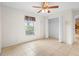 This cozy bedroom features a large window, closet and tile flooring at 1576 Naples Cir, Deltona, FL 32738