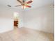 This bedroom features neutral walls, tile flooring, and ensuite bathroom at 1576 Naples Cir, Deltona, FL 32738