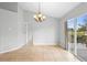 Dining area featuring modern chandelier, tile floors, and sliding door to the patio at 1576 Naples Cir, Deltona, FL 32738