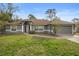 Charming single-story home with a well-maintained lawn and neutral gray exterior paint at 1576 Naples Cir, Deltona, FL 32738