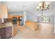 Stylish kitchen with stainless appliances, wooden cabinets, granite countertops, and tile flooring at 1576 Naples Cir, Deltona, FL 32738